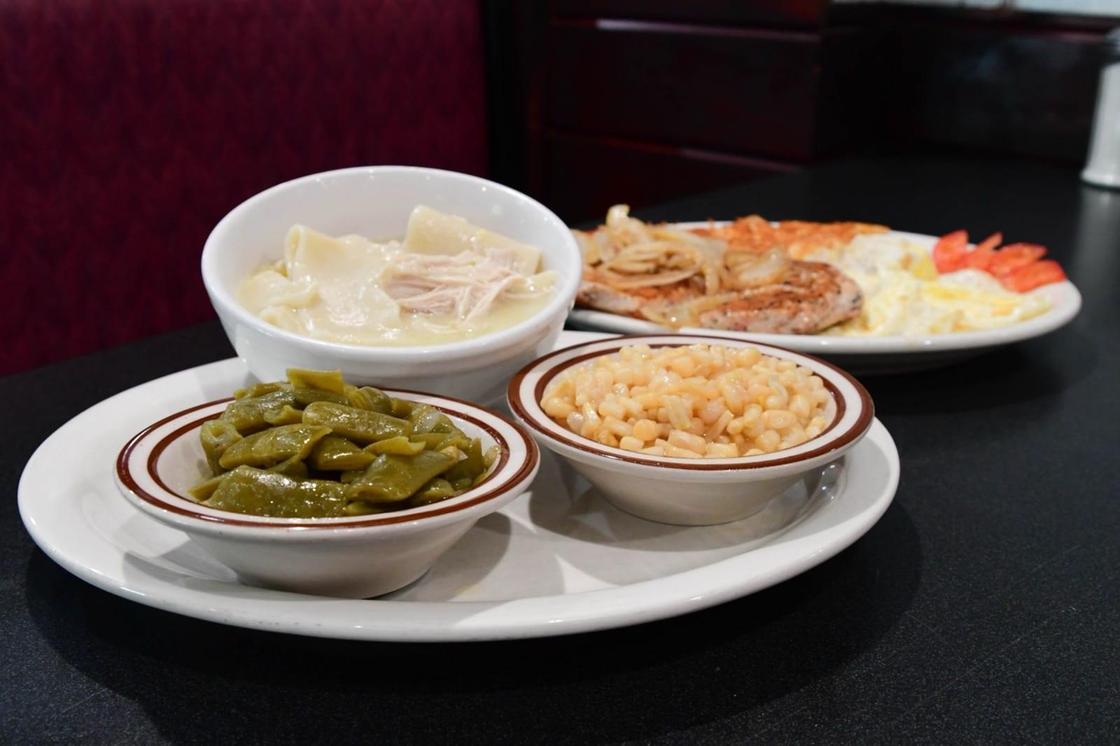 Southern meat-and-three plate with chicken and dumplings, green beans, corn and a grilled pork chop at Ranch House Makarios in Vestavia Hills, AL